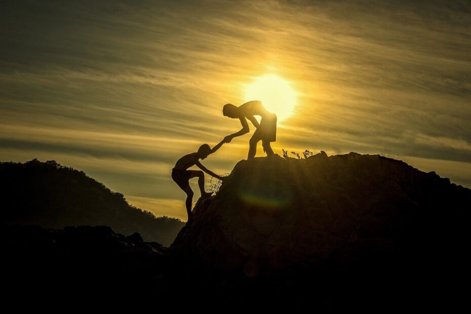 Illustre la couveuse-une personne en aide une autre pour gravir la montagne